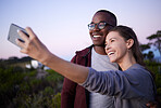 Interracial couple, phone and smile for selfie, journey or travel adventure or trip together in the nature outdoors. Happy woman holding smartphone for photo with man smiling in happiness for holiday