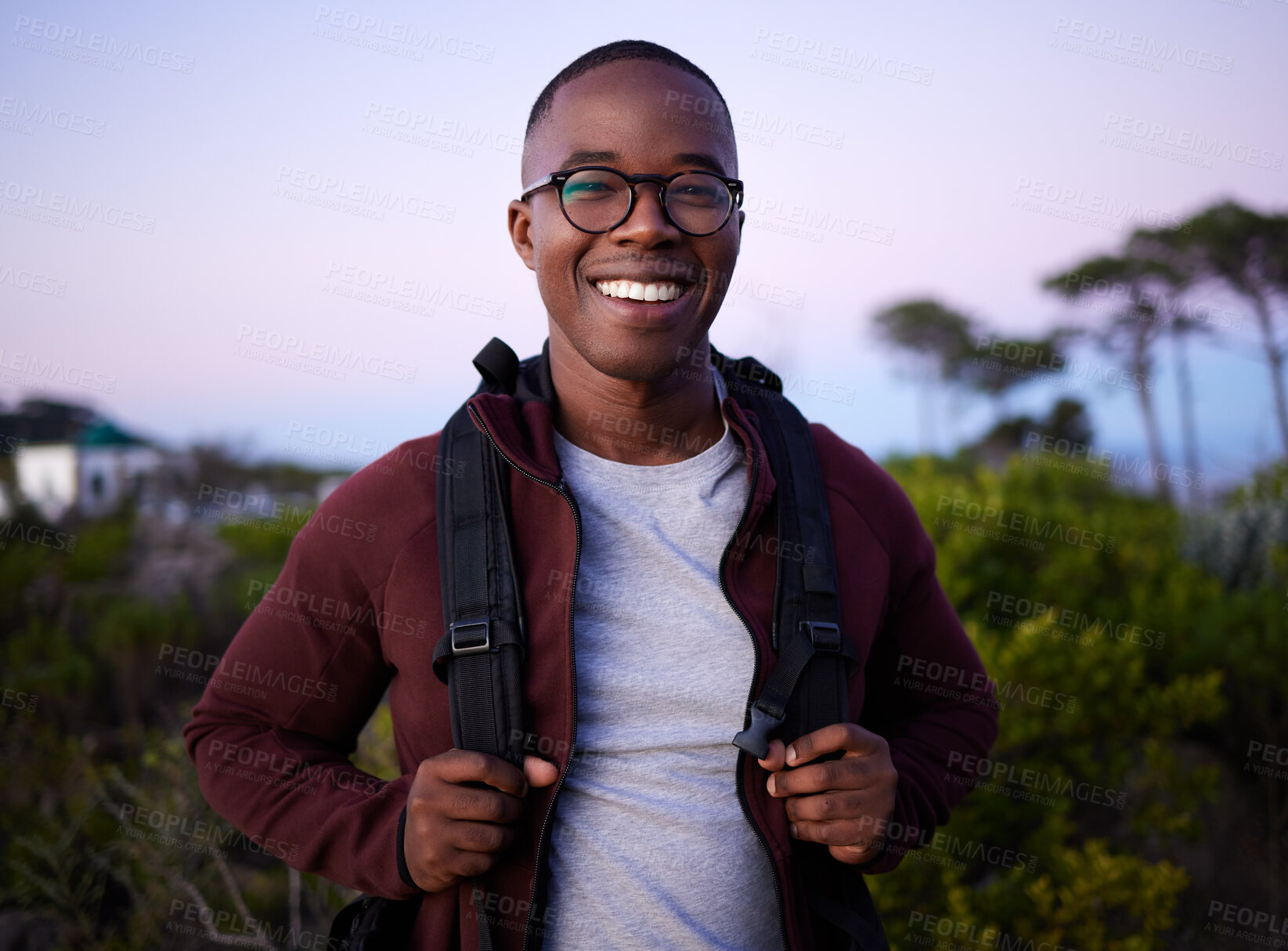 Buy stock photo Portrait, hiking and nature with a black man outdoor for health, freedom or adventure in the evening. Hike, hobby and recreation with a handsome young male hiker carrying a backpack alone outside