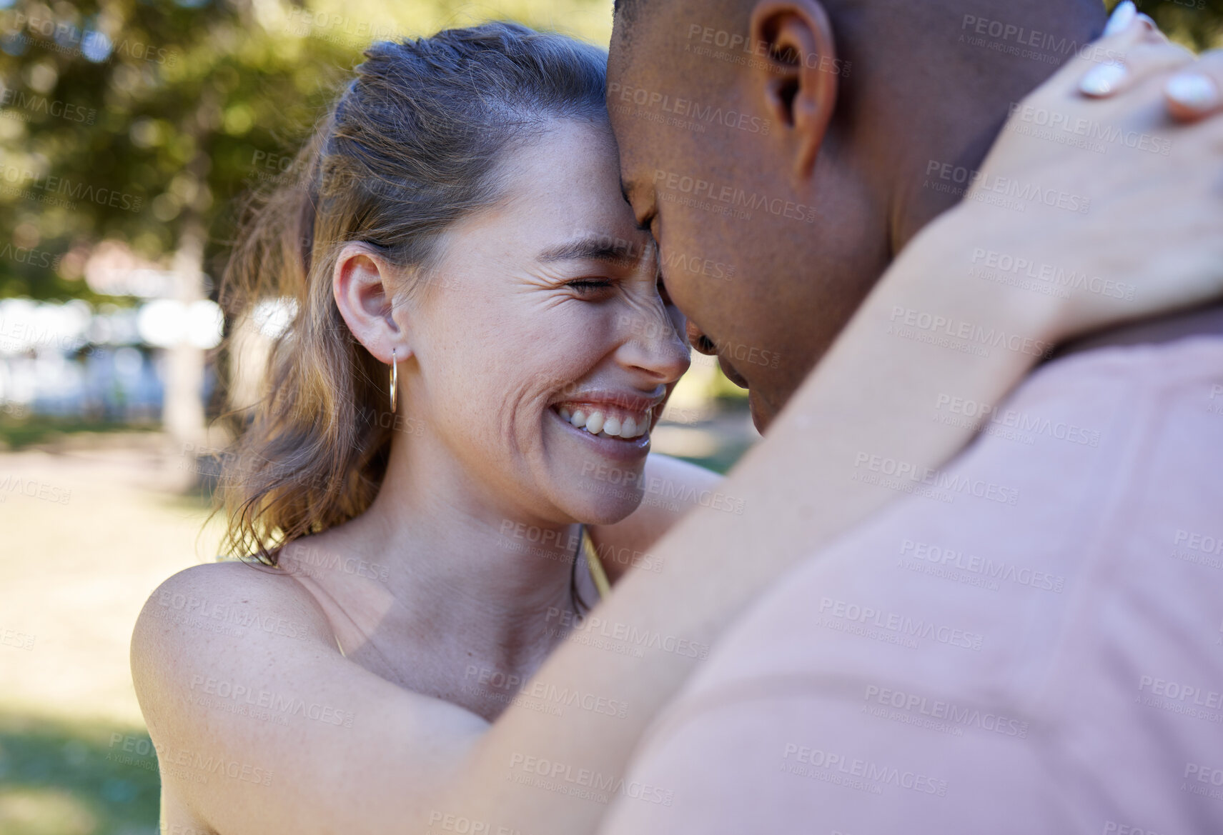 Buy stock photo Happy, hug and interracial couple love, laugh and fun at park date in diversity, summer celebration or romance. Black man, partner or people smile together in garden excited for anniversary in nature