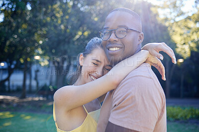 Buy stock photo Summer, love and interracial with a couple bonding outdoor together in a park or natural garden. Nature, diversity and romance with a man and woman hugging while on a date outside in the countryside