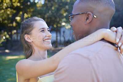 Buy stock photo Interracial couple, smile and hug for romantic love, care or embracing relationship in a nature park. Happy black man hugging woman and smiling in happiness for romance, embrace or support outside