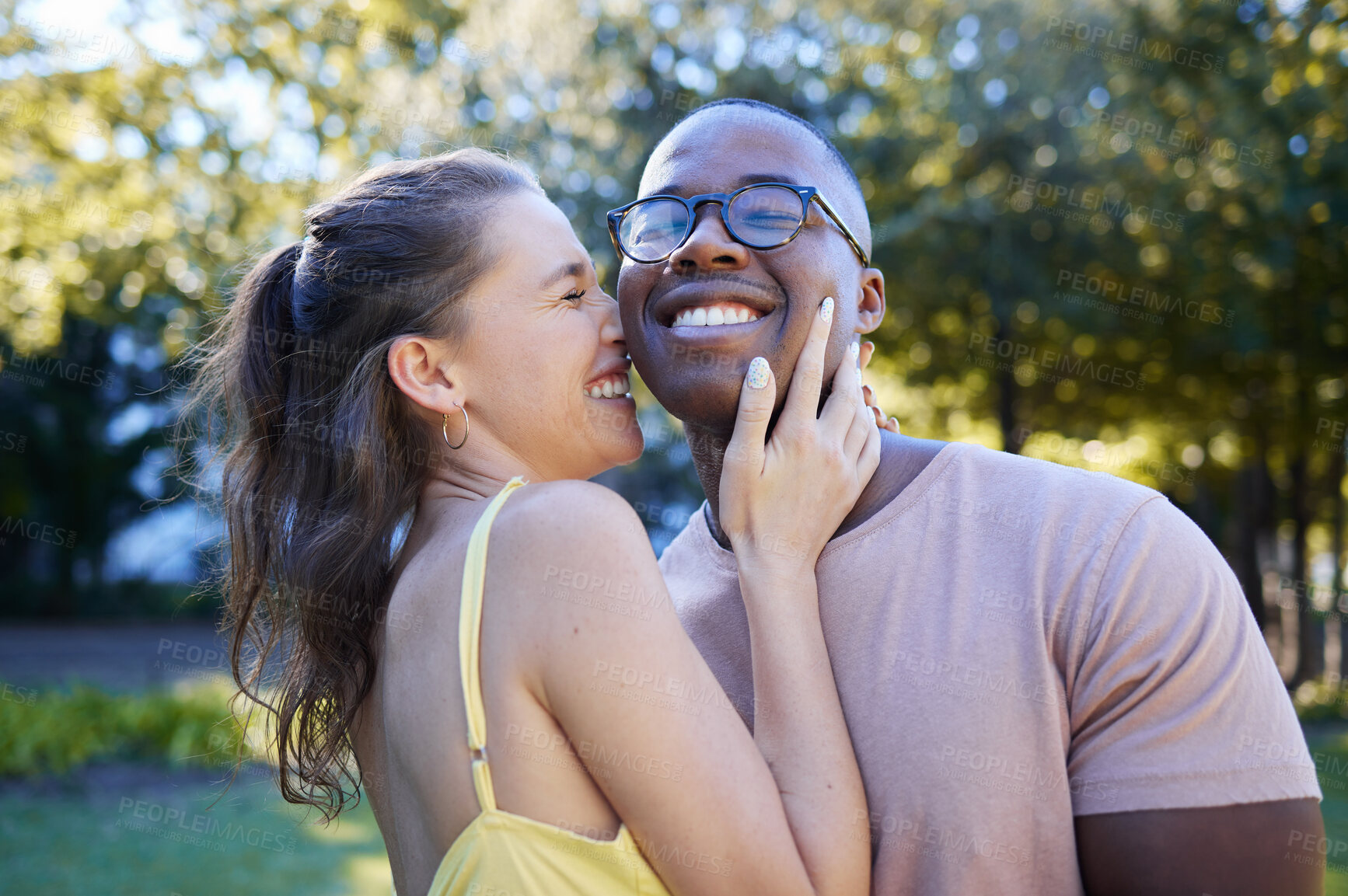 Buy stock photo Summer, love and laugh with an interracial couple bonding outdoor together in a park or garden. Nature, diversity and romance with a man and woman hugging while on a date outside in the countryside