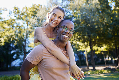 Buy stock photo Interracial couple, love and portrait of people with support, care and smile on a summer park adventure. Piggyback, hug and young man and woman outdoor on date together happy about bonding in nature