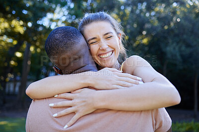 Buy stock photo Love, interracial and couple hug, outdoor and smile for bonding, romance and loving together. Romantic, black man and woman embrace in nature, relationship and happiness in park, intimate and dating