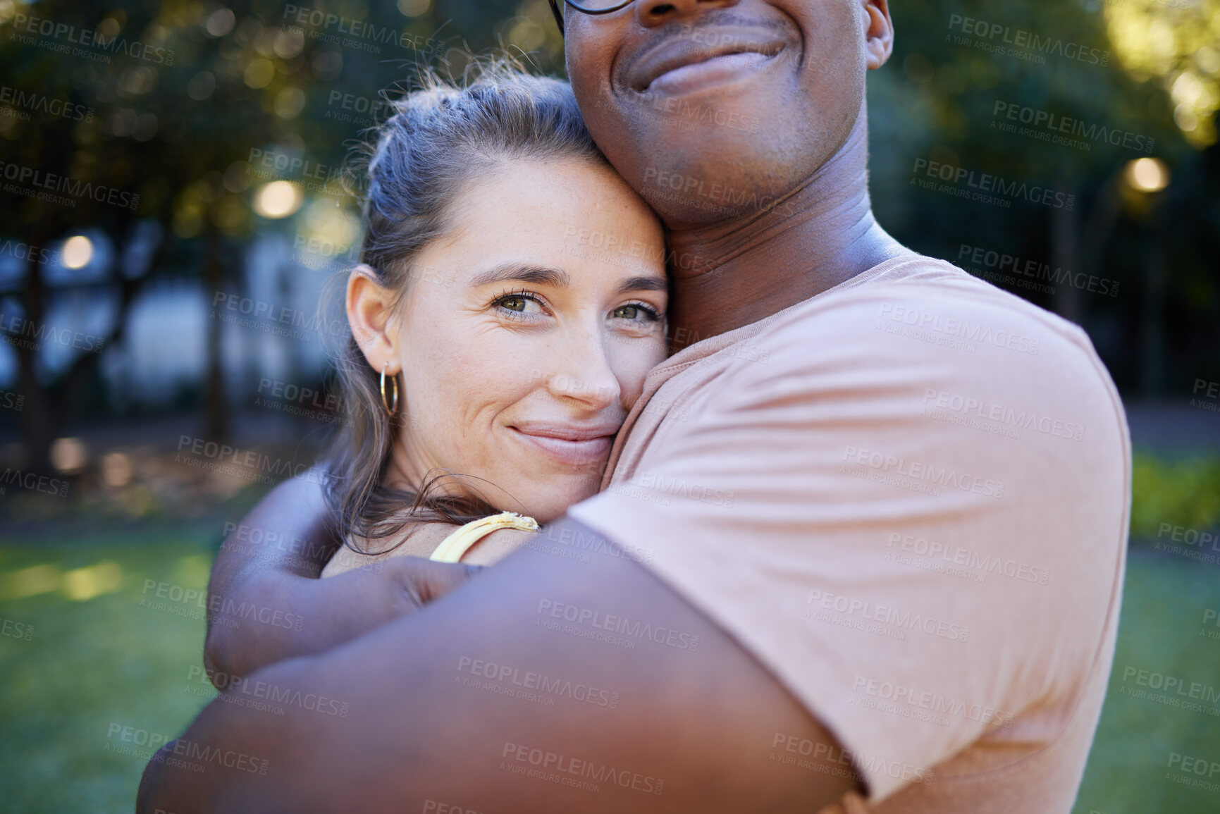 Buy stock photo Interracial relationship hug, park and woman with smile, care and love with black man, reunion and happiness. Multicultural embrace, happy couple and diversity on nature adventure, bonding and spring