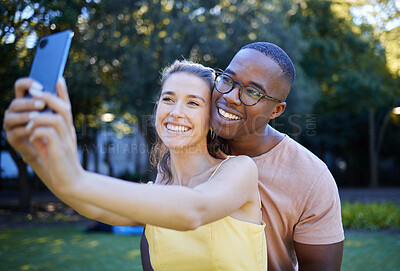 Buy stock photo Selfie, phone and interracial couple smile in park enjoying weekend, summer holiday and quality time together. Nature, dating and happy man and woman relax, calm and hug to take picture on smartphone