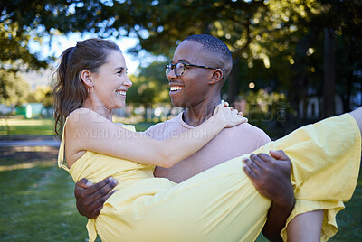 Buy stock photo Love, park and carrying with an interracial couple bonding outdoor together on a romantic date in nature. Summer, romance and diversity with a man and woman dating outside in a green garden