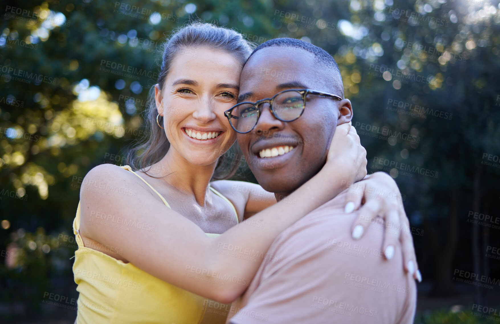 Buy stock photo Portrait, couple on a date and hug with love in nature, outdoor in park with commitment in interracial relationship. Trust, support and happy people, black man and woman smile on face with fresh air