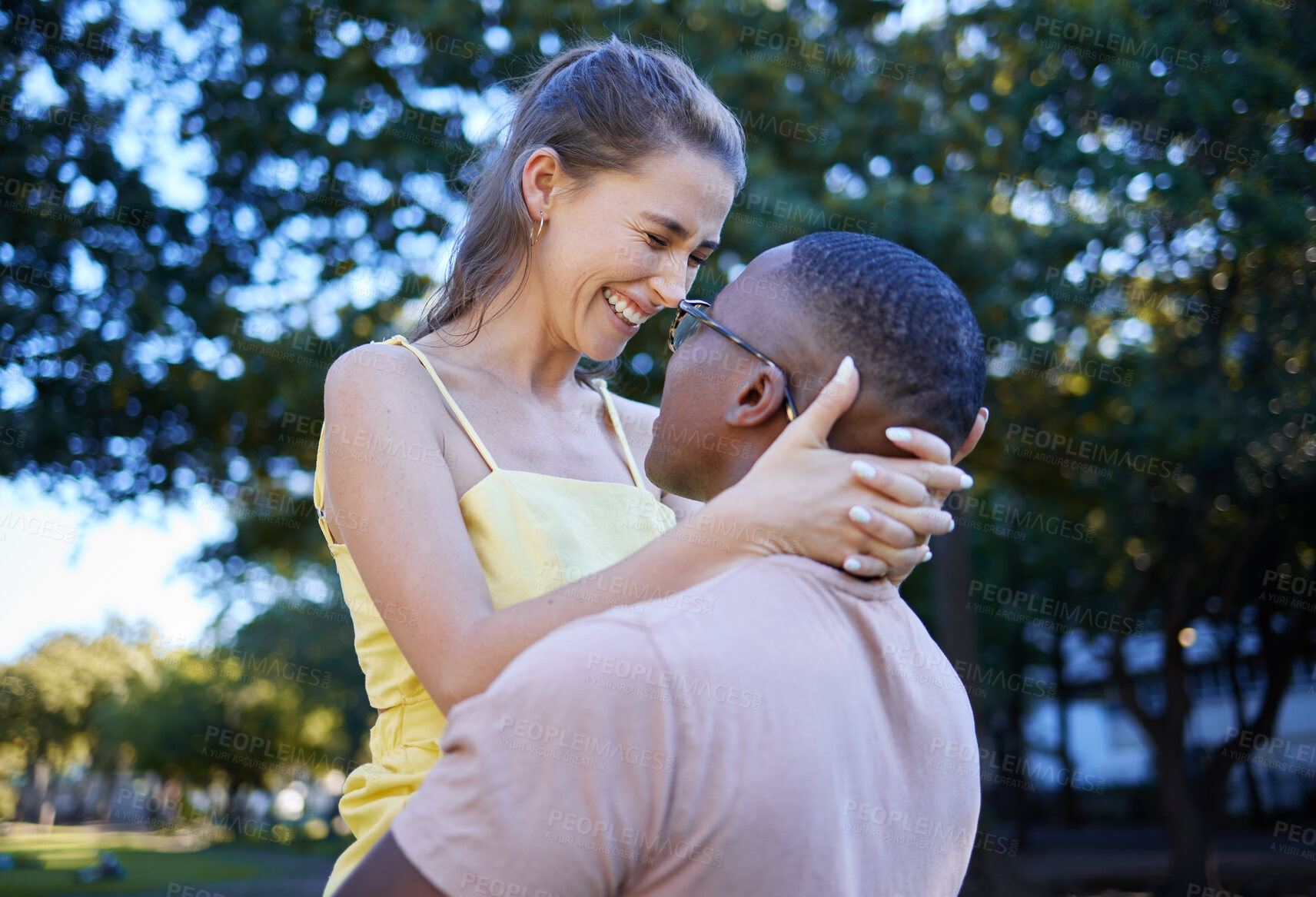 Buy stock photo Love, park and laugh with an interracial couple bonding outdoor together on a romantic date in nature. Summer, romance and diversity with a man and woman dating outside in a green garden