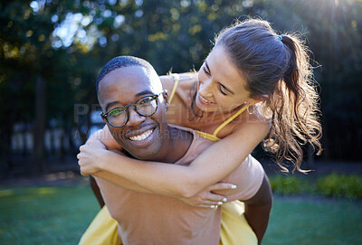 Buy stock photo Piggyback, smile and portrait of couple at park in interracial love, nature wellness and support walking in summer. Trees, freedom and happy black man with woman or people having fun together on date