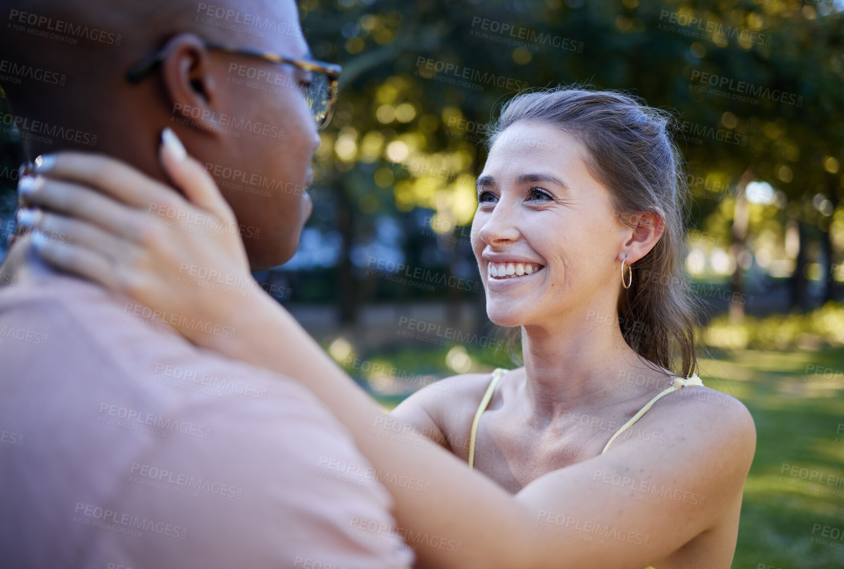 Buy stock photo Interracial love, couple and park for date, summer holiday and outdoor wellness with hug, care and commitment. Happy, young and diversity people in a green garden, nature and natural fun together