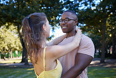 Buy stock photo Summer, love and diversity with a couple bonding outdoor together in a park or natural garden. Nature, interracial and romance with a man and woman hugging while on a date outside in the countryside