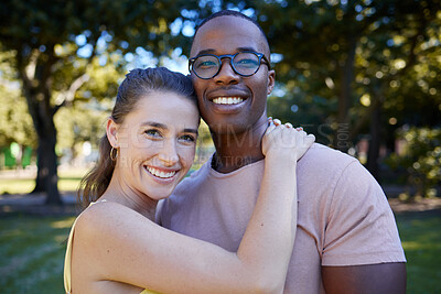 Buy stock photo Couple hug, date outdoor and portrait with nature, love and commitment in park with interracial relationship. Trust, support and happy people, black man and woman with smile on face and content