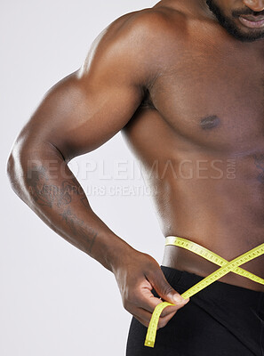 Buy stock photo Tape, fitness and diet man isolated on white background for lose weight, bodybuilder and training and wellness. Bodybuilding, athlete or sports black person measuring his waist, stomach or muscle