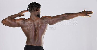 Buy stock photo Back, body and mockup with a model black man posing in studio on a gray background for fitness or exercise. Muscle, health and wellness with a strong male athlete standing or flexing for power
