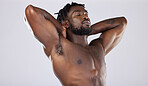 Nude body, skin and black man, muscle and content with strong person, fitness isolated on studio background. Muscular, bodybuilder and natural cosmetics, clean and peace with skincare and naked 