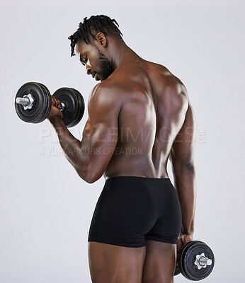 Buy stock photo Dumbbell, exercise and fitness of strong black man doing muscle workout in studio. Body of a sexy bodybuilder in underwear training with weights for power, health and wellness or growth motivation