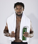 Black man, exercise and portrait with towel and water bottle for sports training in studio. Health and wellness of a sexy male bodybuilder model with bottle for fitness workout, goals and strong body