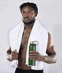 Exercise, fitness and black man with a towel and water for sports training in studio. Health and wellness of a sexy male bodybuilder model thinking about workout, goal and body progress with a bottle