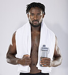 Black man, towel and water for fitness portrait of sports person in studio for strong body. Health and wellness of sexy male bodybuilder model after exercise, workout and power training with a bottle