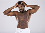Muscular, portrait and black man with cosmetics, skincare and confident guy on grey studio background. African American male, body builder or person with muscles, torso or dermatology for smooth skin