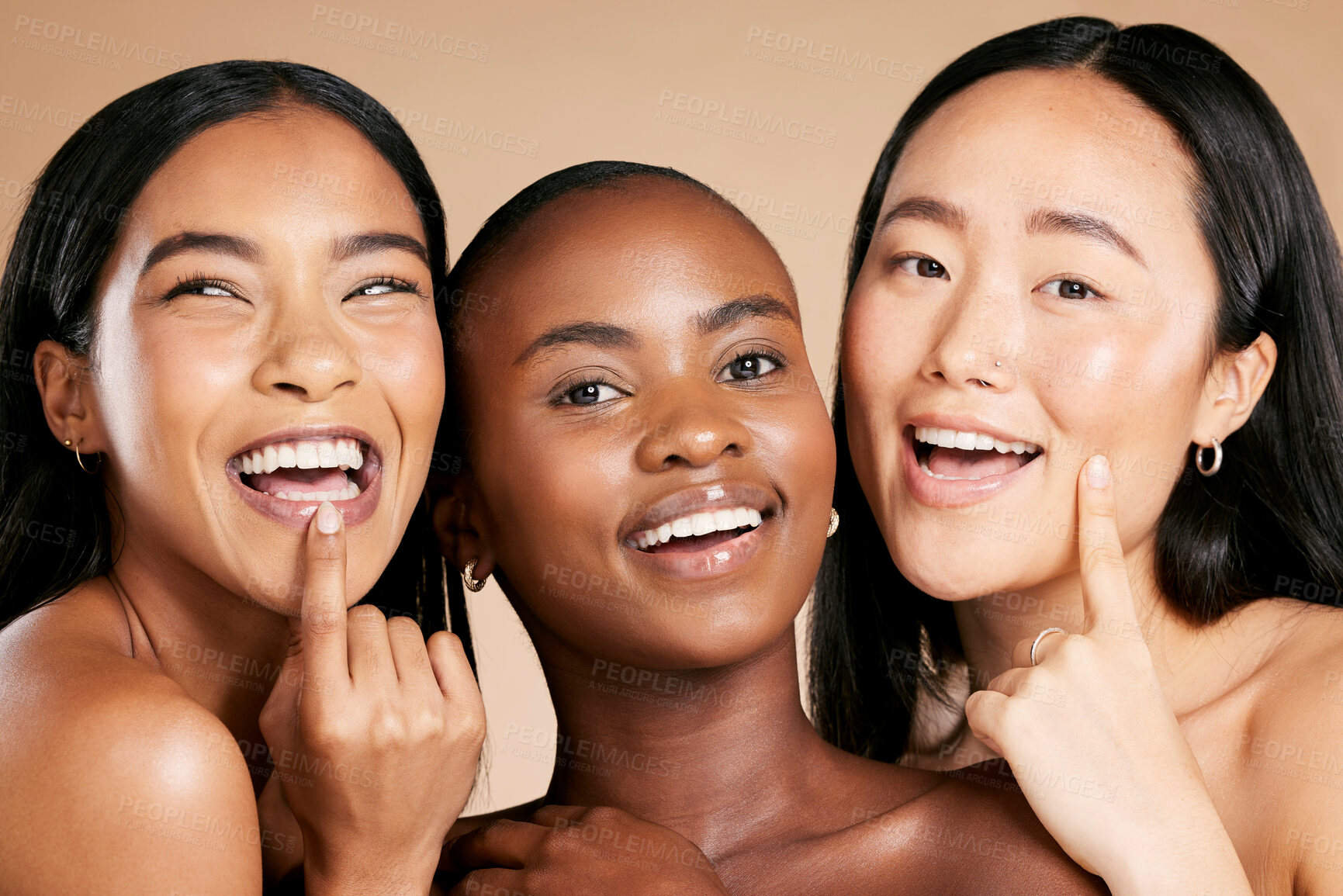 Buy stock photo Skincare, beauty and multicultural women smile and point at skin on studio background. Health, wellness and luxury cosmetics, healthy care and happy, beautiful and friendly people with natural makeup