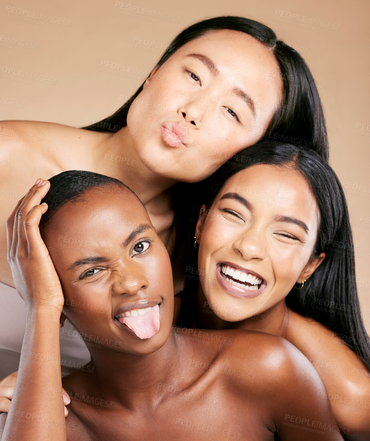 Buy stock photo Diversity, beauty and women in crazy portrait smile together, skincare friends on studio background. Health, wellness and luxury cosmetics for beautiful multicultural people in makeup with tongue out