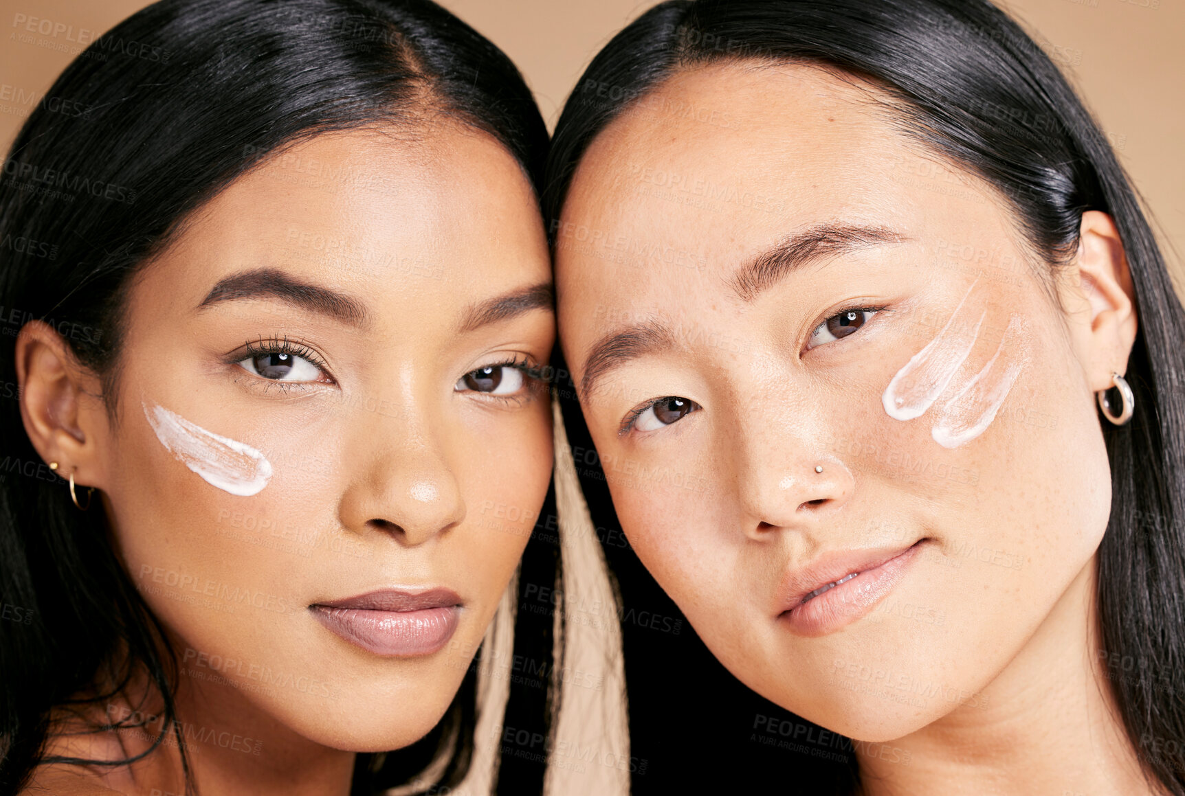 Buy stock photo Skincare, beauty cream and diversity women portrait in studio for dermatology, makeup and cosmetics. Asian and black person together for glow, spa facial and healthy face skin of friends for wellness