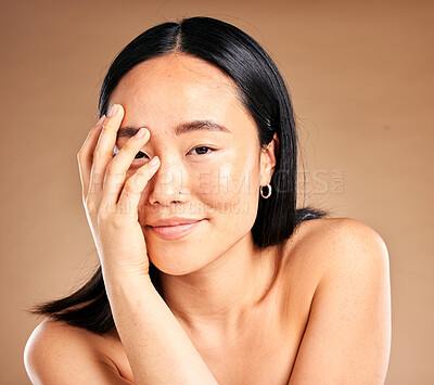 Buy stock photo Portrait, beauty and skincare with a model asian woman in studio on a beige background for natural treatment. Wellness, aesthetic or facial with an attractive young female posing to promote antiaging