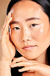 Asian woman, hands and beauty portrait for skincare wellness, facial dermatology and luxury natural skin glow in studio. Young model, calm face and healthy cosmetics treatment or relax body care 
