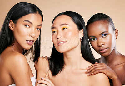 Buy stock photo Diversity, skincare and women with cosmetics, dermatology and wellness on brown studio background. Makeup, multiracial and ladies with healthy, smooth and clear skin for confidence and wellness