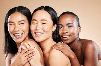 Buy stock photo Makeup, diversity and woman happiness together for support, facial wellness and cosmetics dermatology care in brown background studio. Model, smile and interracial beauty inclusion with skin glow