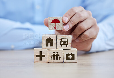 Buy stock photo Healthcare, life insurance and building blocks with hands of man for safety, medical and planning. Future, investment and retirement with wooden cube tower on table for savings, property and medicine