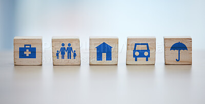 Buy stock photo Medical, house and life insurance on blocks background for family clinic, safety and healthcare icon or sign. Future goals, risk management and car or home cover with umbrella on wood for services