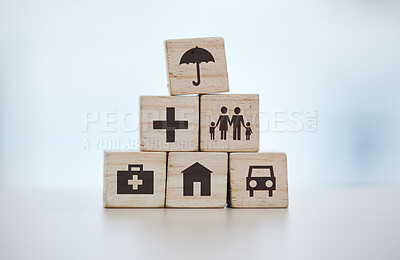 Buy stock photo Building blocks, pyramid and life insurance for medical, car loan or home on background mockup, table or desk mock up. Zoom, wooden and cubes for house risk management, security and future protection