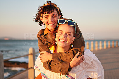 Buy stock photo Lesbian, portrait and couple of friends at the beach in piggyback, support and happy for lgbtq love. Sunset, sea and smile of women or gay people on summer date with pride, freedom and gen z holiday