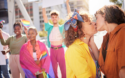 Buy stock photo Love, kiss and couple of friends in city with rainbow flag for support, queer celebration and relationship. Diversity, lgbtq community and group of people enjoy freedom, happiness and pride identity