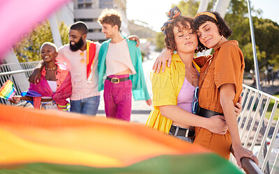 Buy stock photo Lgbt, city and couple of lesbian friends hug with rainbow flag for support, queer celebration and parade for love. Diversity, lgbtq community and group of people enjoy freedom and pride identity