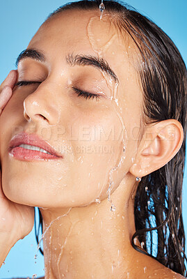 Buy stock photo Woman, shower water and face for beauty, skincare and peace with blue studio background. Calm, relax and healthy young person doing morning self face for skin glow with clean beauty treatment
