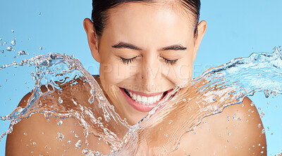 Buy stock photo Water, beauty and skincare, woman with smile, splash and sustainability on clean blue background. Dermatology, fresh and happy person cleaning face with marketing for luxury anti aging cosmetics.