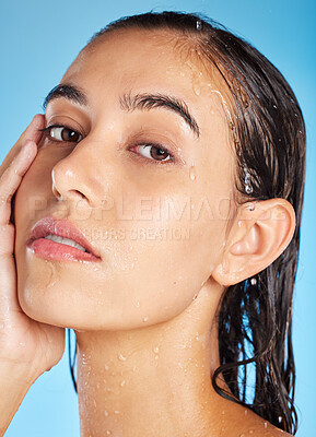 Buy stock photo Portrait, water and woman cleaning, skincare and dermatology for health, wellness and on blue studio background. Face, lady and female with hygiene, wet and shower for natural beauty and cosmetics