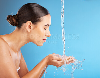 Buy stock photo Woman, hands and water for skincare hydration, hygiene or face wash against a blue background. Beautiful female in facial cleaning, washing or cleansing for skin rehydration or dermatology on mockup