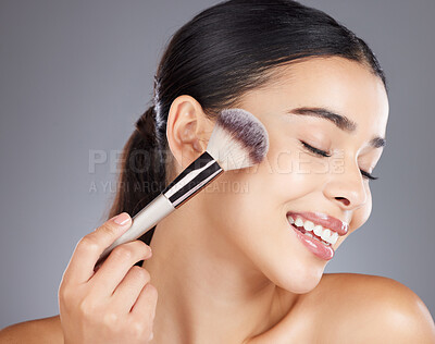 Buy stock photo Makeup, beauty or woman with a brush for facial cosmetics or luxury skincare products. Face, aesthetic or happy beautiful girl model smiles grooming in self care routine isolated on studio background