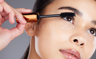 Buy stock photo Face, beauty makeup and woman with mascara in studio isolated on gray background. Cosmetics, aesthetics and closeup of young female model with brush, tool or product for care of eyelashes or wellness