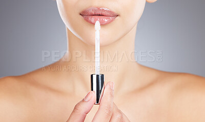 Buy stock photo Woman, lips and lip gloss application for beauty, makeup shine and skincare wellness in grey background studio. Model, lipstick tool or brush for cosmetics dermatology glow or luxury salon product