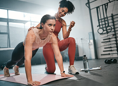 Buy stock photo Personal trainer, fitness and stopwatch with a black woman coaching a client in a gym during her workout. Health, exercise or training and a female athlete doing a plank with her coach recording time