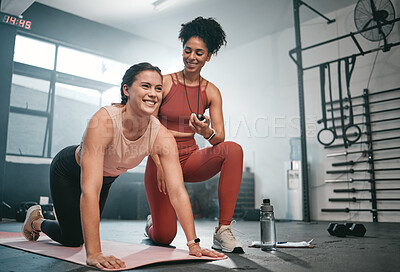 Buy stock photo Personal trainer, exercise and stopwatch with a black woman coaching a client in a gym during her workout. Health, fitness or training and a female athlete ready to plank with a coach recording time