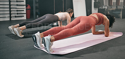 Buy stock photo Gym floor, health and training woman doing plank exercise, performance workout or core muscle building for body self care. Ground, commitment and wellness for team, people or friends in fitness class
