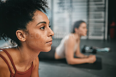 Buy stock photo Black woman, gym focus and plank exercise of a person on the floor busy with workout and wellness. Sports, ground training and strength performance challenge of girl friends at a fitness health club
