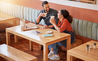 Buy stock photo Coffee, cafe and barista couple at table drinking, talking and laughing at funny meme. Small business, owners or happy man and woman on break with caffeine or espresso while having comic conversation
